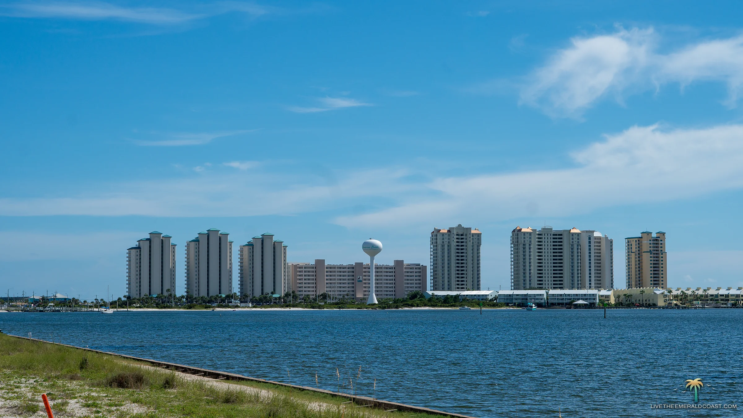 The Navarre Beach skyline and water tower seen across Santa Rosa Sound