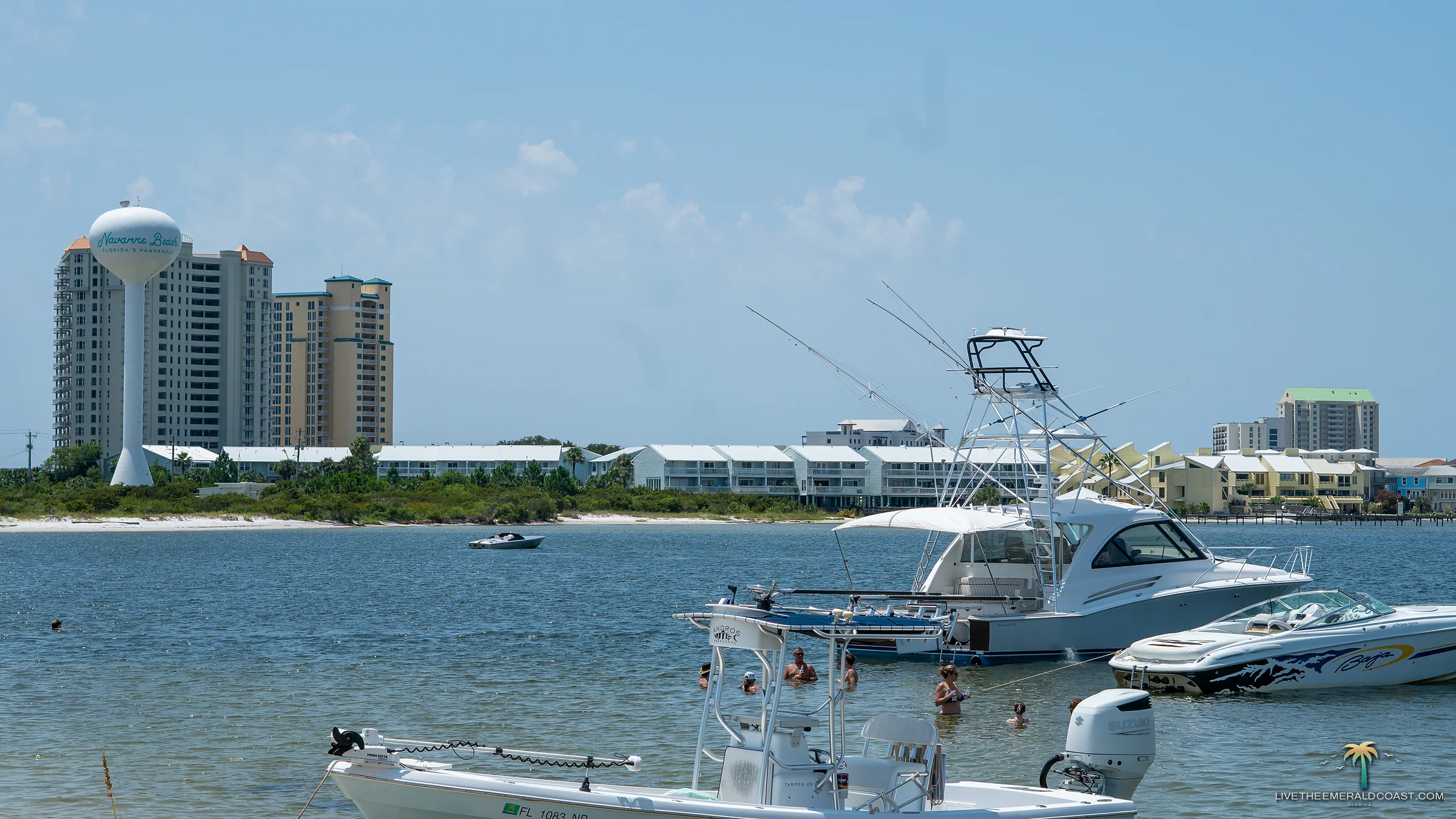 Boats anchored on the sound side sandbar with the Navarre Beach water tower and condominiums beyond, Navarre Beach, Florida